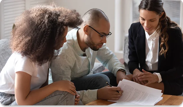Couple signing their green card paperwork with a Rush In consultant