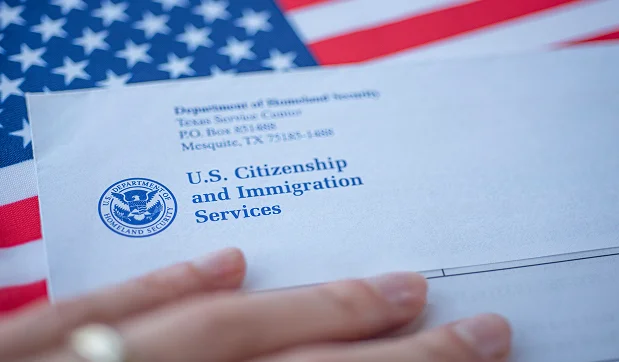 USCIS envelope resting on an American flag