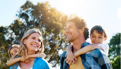 Family of four outdoors on a sunny day